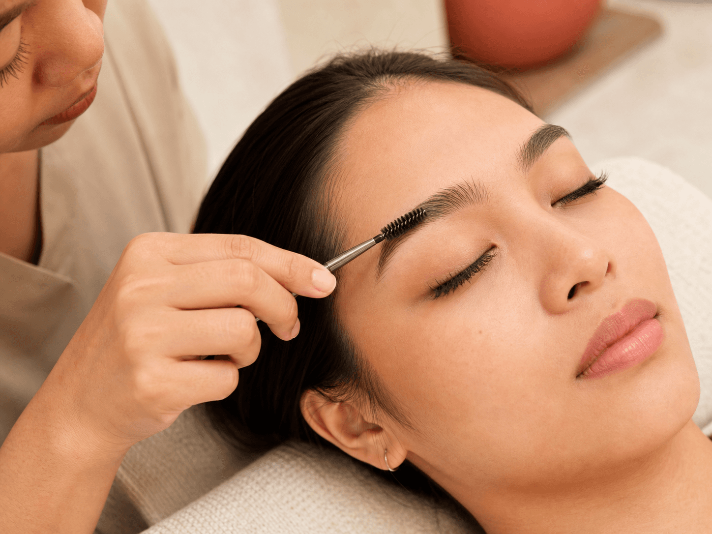 A Filipina client receiving an eyebrow and lash treatment