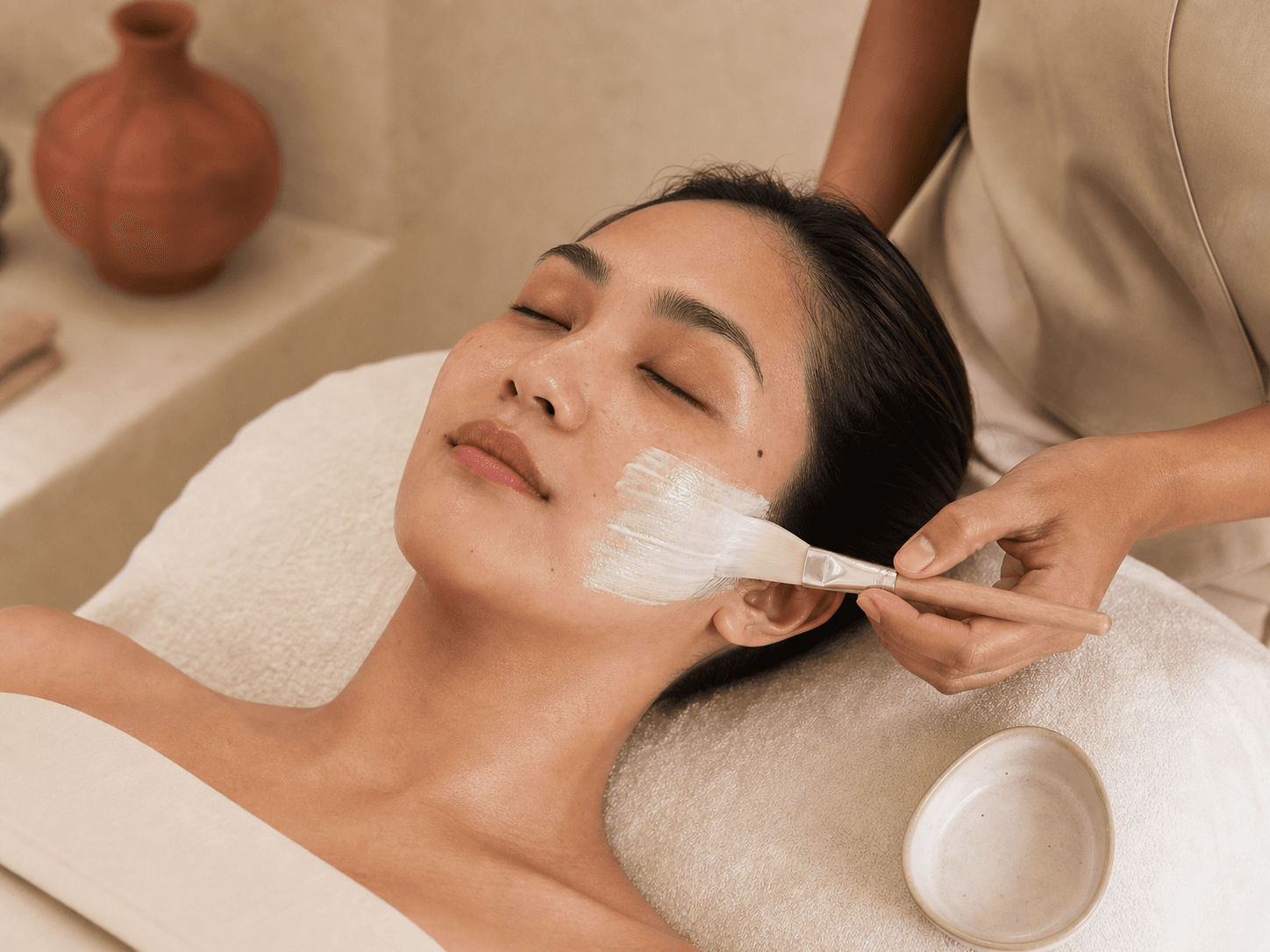 A Filipina client receiving a facial treatment
